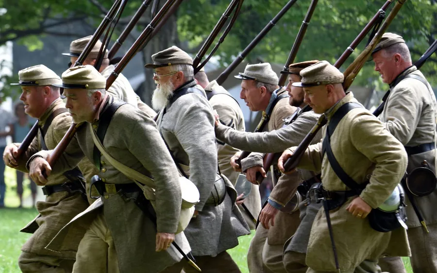 Costumed living-history interpreters marching during a Century Village program
